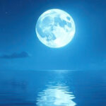 Aquarius Full Moon, 2025. Bright full moon shining and reflecting over a vast body of water.