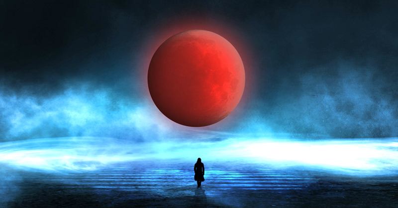 A person stands on a misty landscape facing a large red moon—evocative of the 2026 Pisces Full Moon Eclipse—in a dark blue sky, surrounded by swirling fog and light that hints at volatility in the air.
